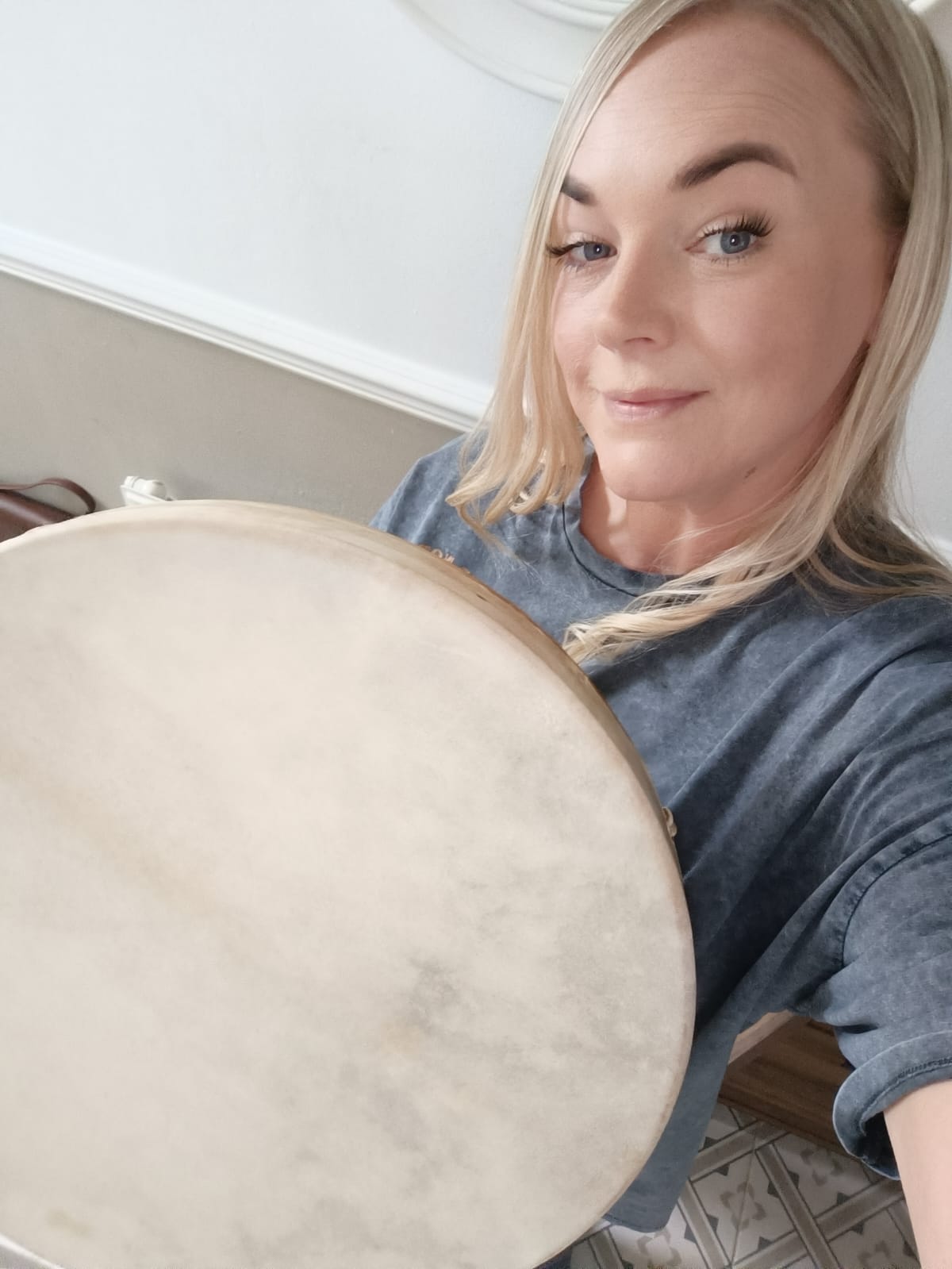 Nicola holding a frame drum